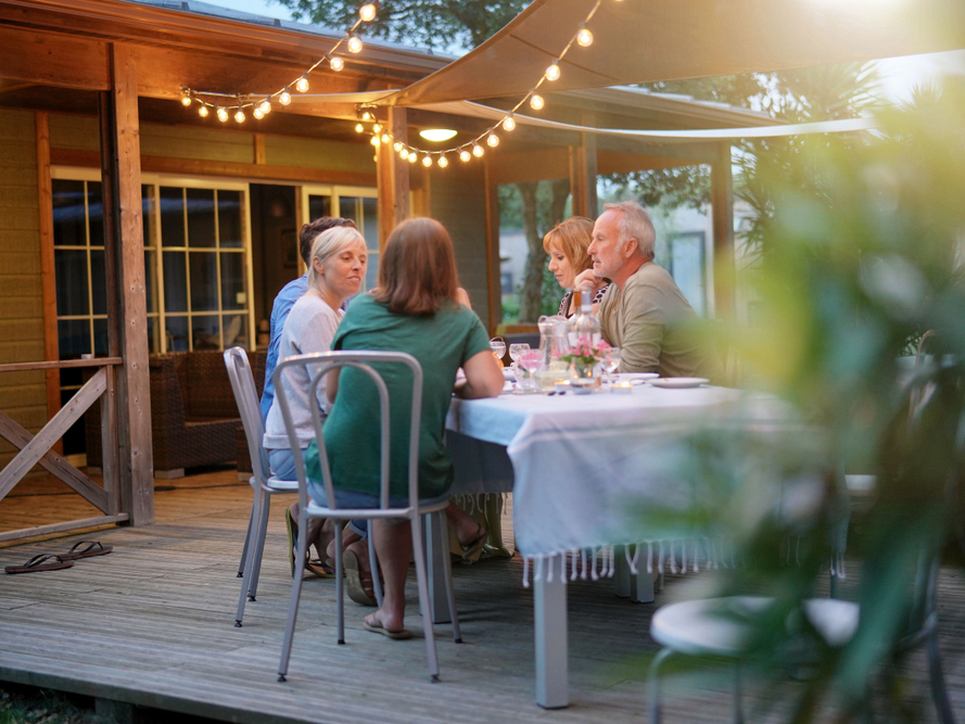 family at dinner table outside