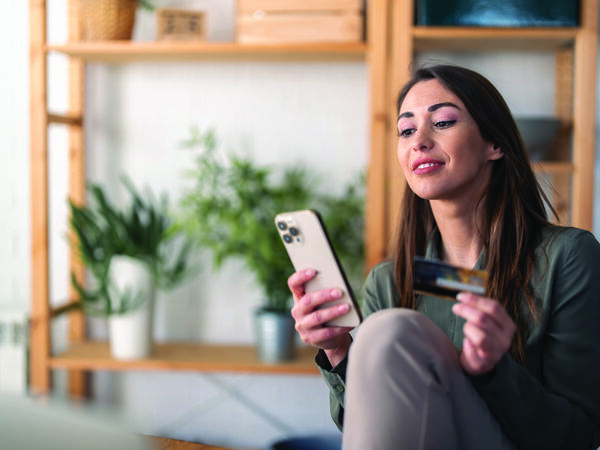 woman on phone with credit card