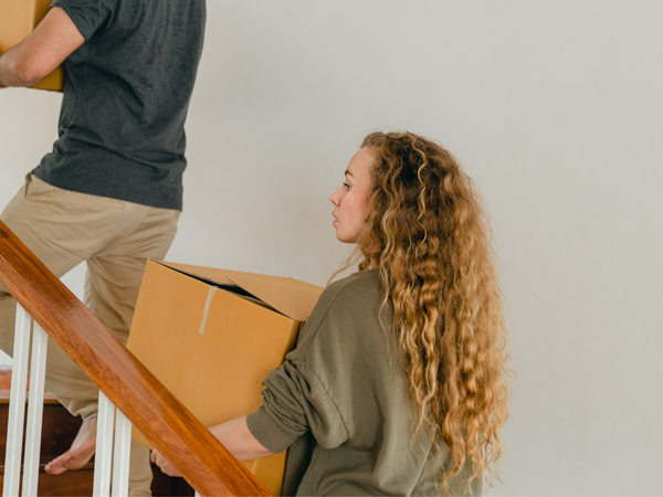 Woman moving boxes upstairs
